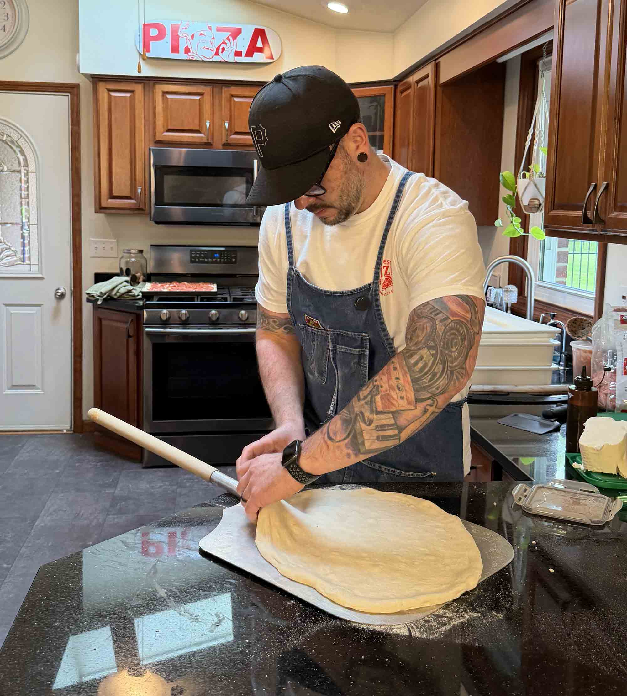 Jesse Wisinski making and evaluating pizza